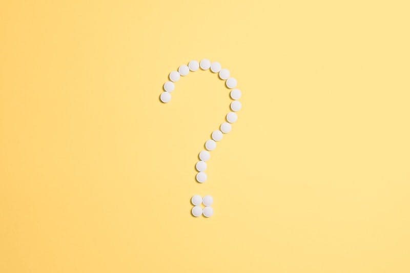 A white question mark on a yellow background