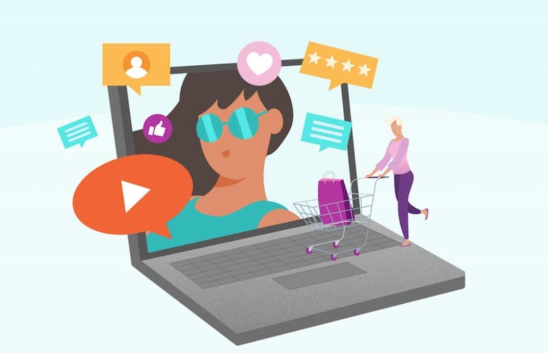 Illustration of a woman with a shopping cart on top of a laptop