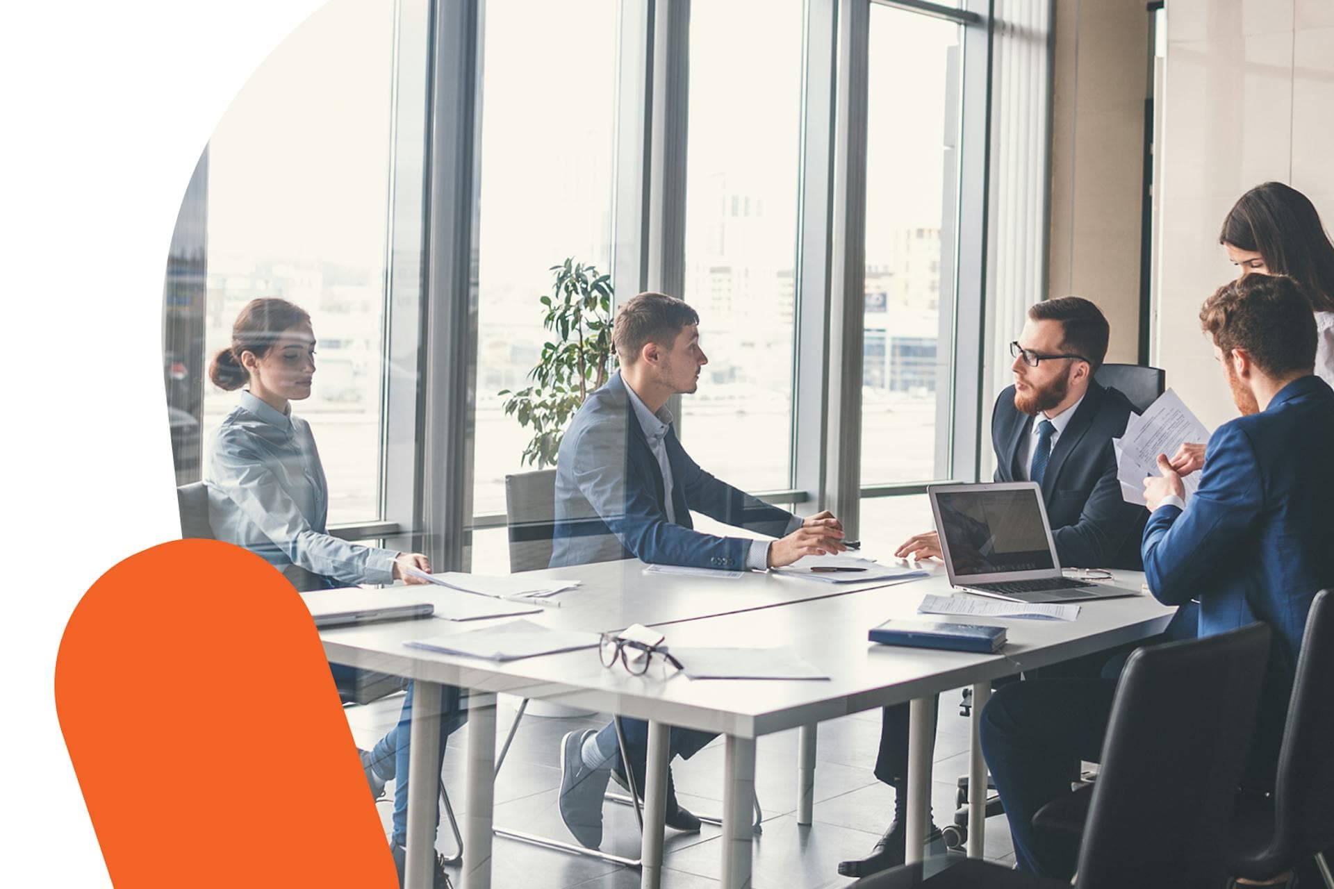 A photo of a group of business people in a meeting room. 