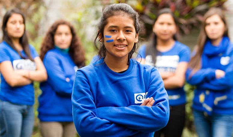 5 teenage girls standing with their arms crossed.