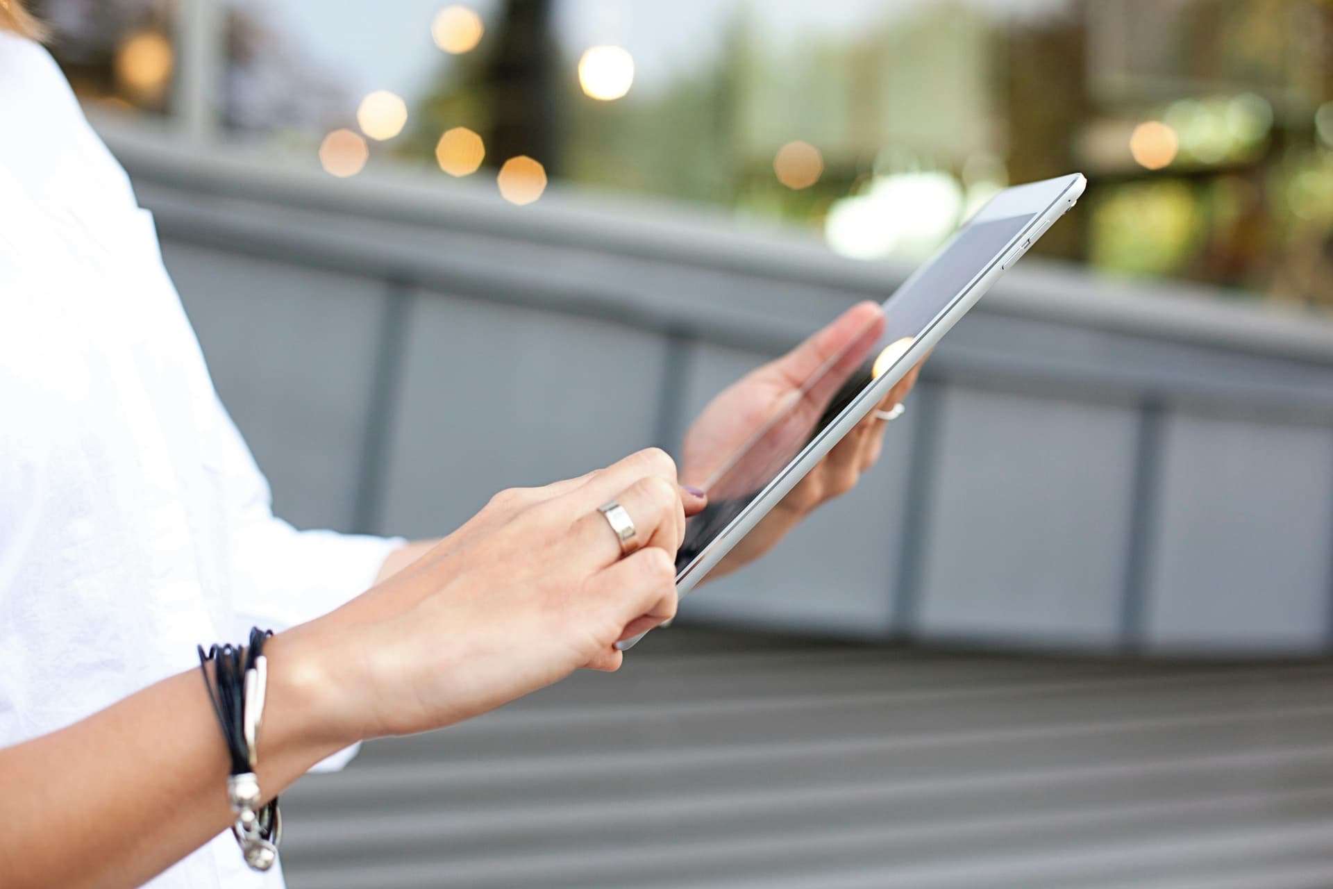 woman holding tablet, writing a press release email